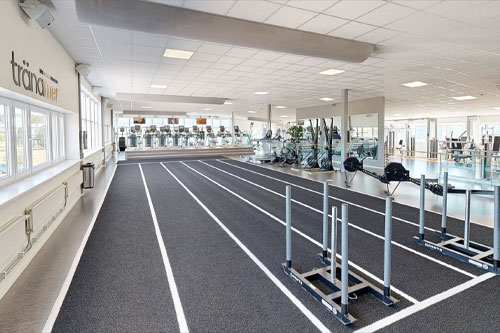 Träna meras gymlokal med olika träningsmaskiner uppställda